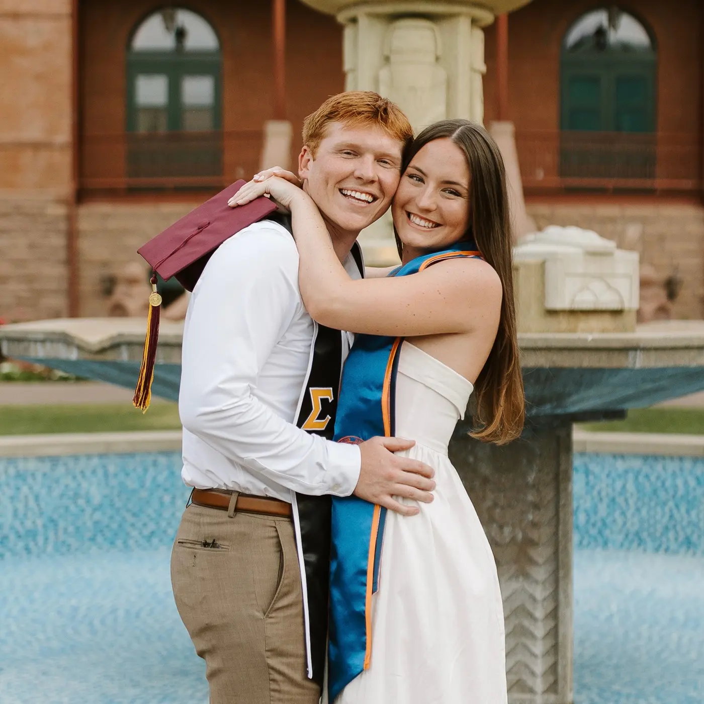 Denae and Kyle in their graduation gowns